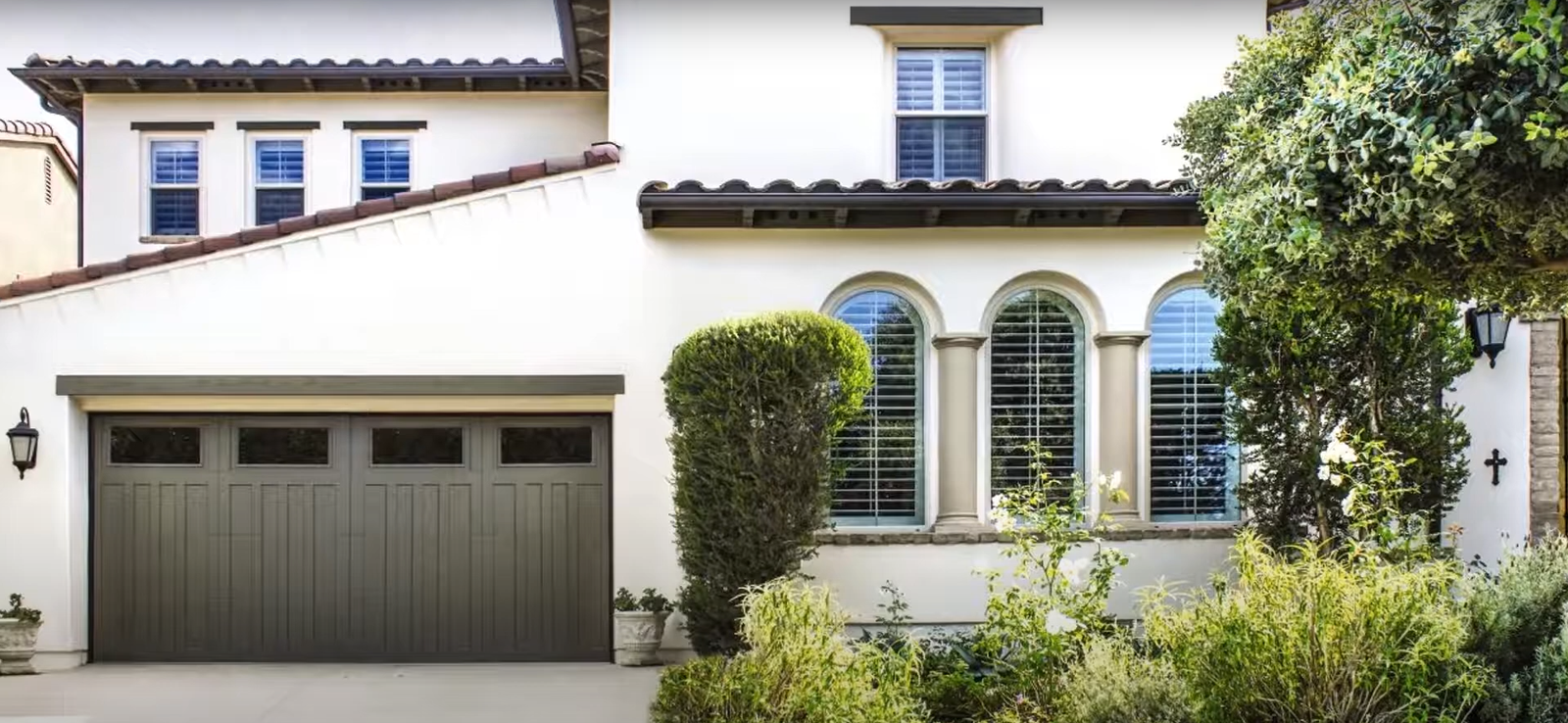 Professional technician performing garage door repair service at a residential property to ensure smooth operation and safety, provided by Local Garage Door Repair Company.