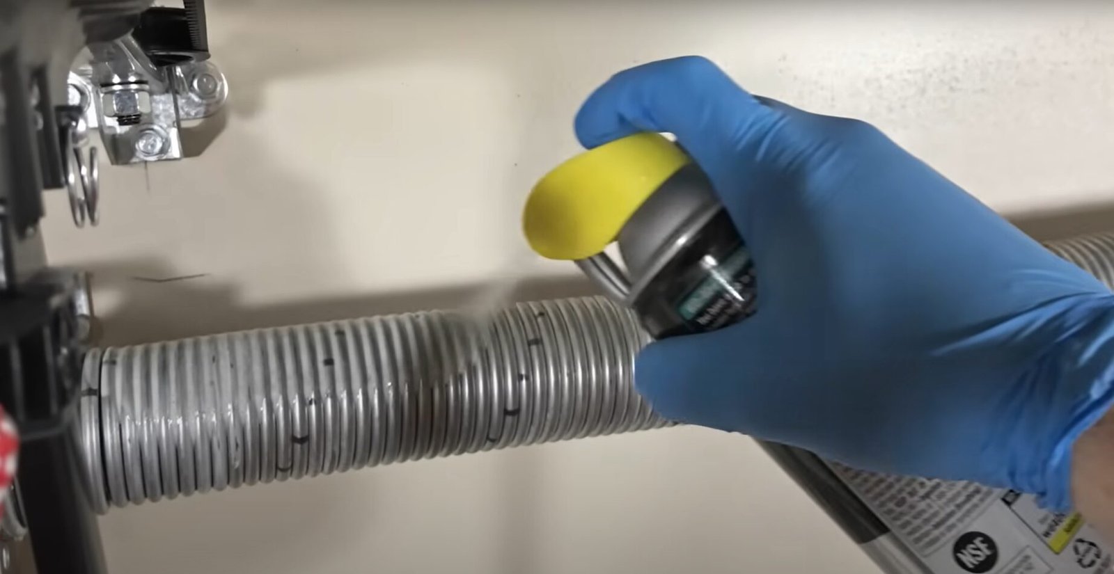 A skilled technician from Local Garage Door Repair Company expertly repairing a garage spring door, ensuring smooth and safe operation.