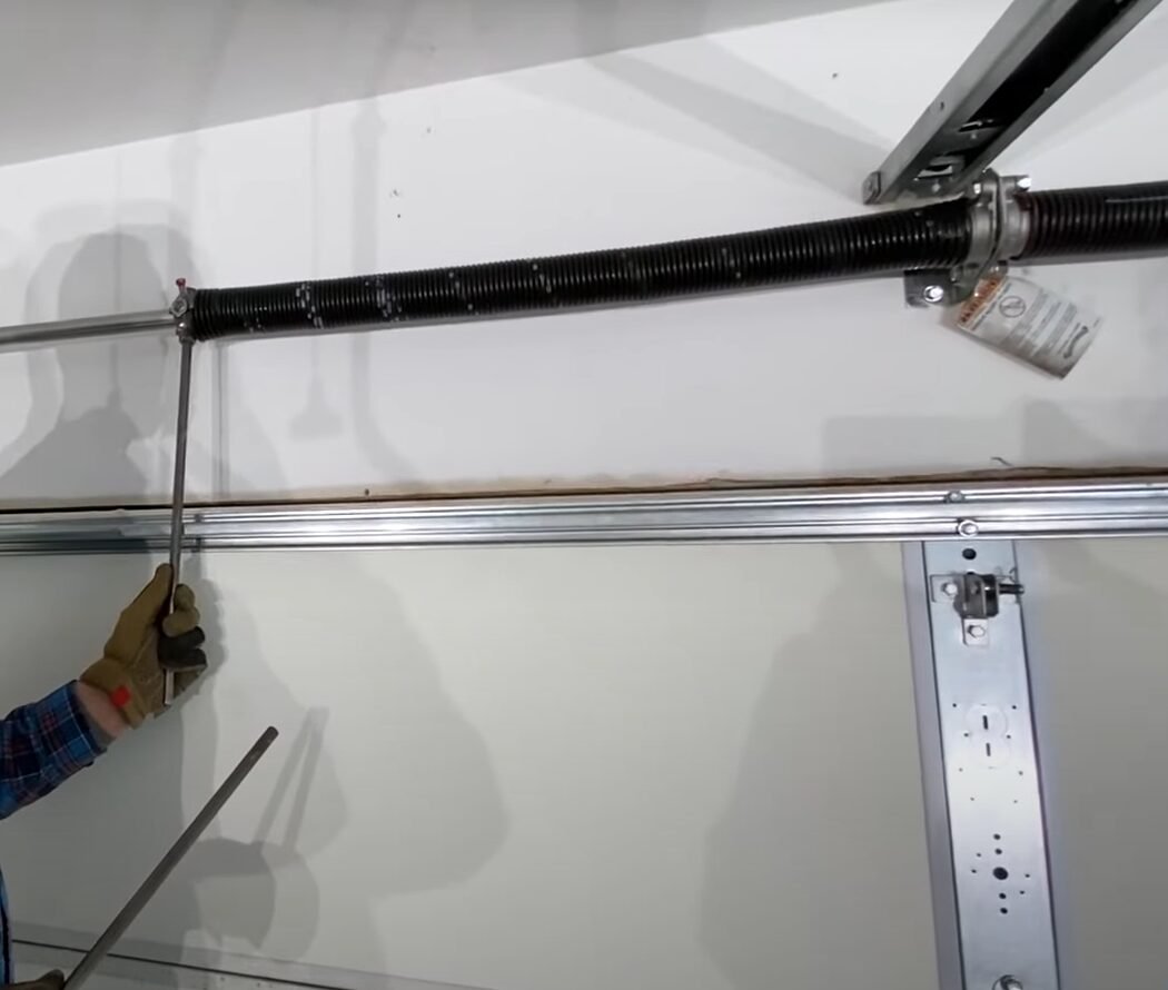 Professional technician performing garage spring door repair at Local Garage Door Repair Company